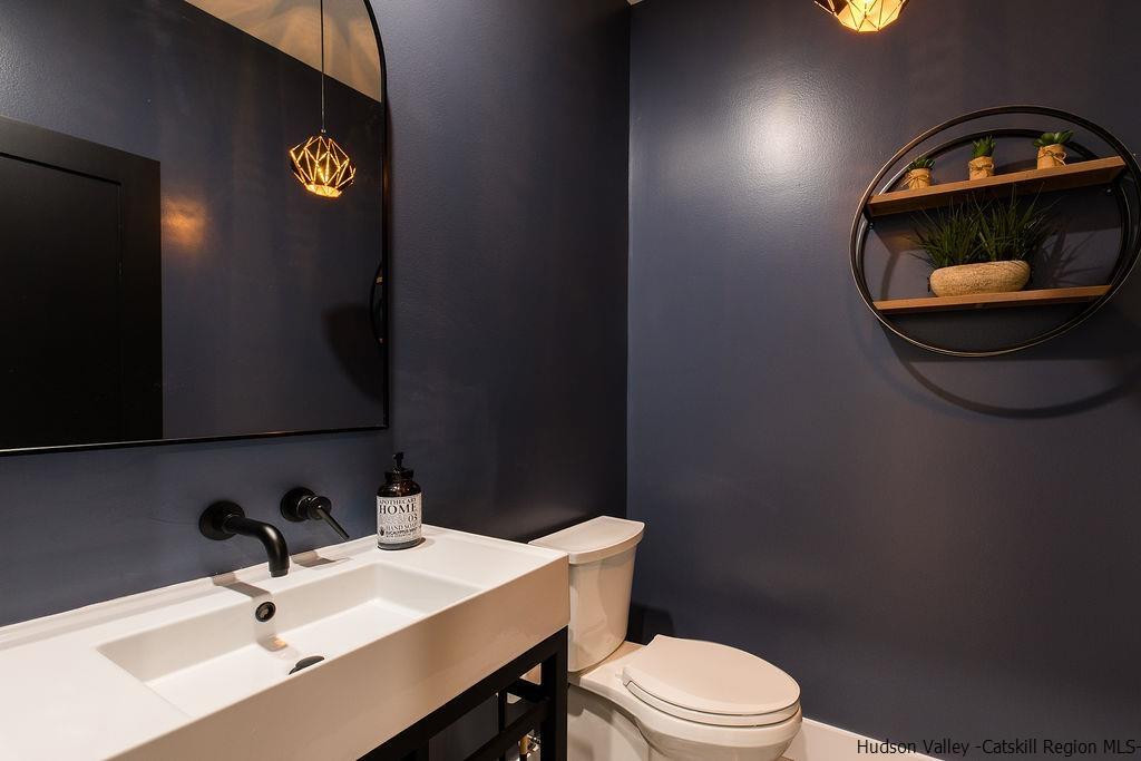 136 Bush Road Stone Ridge, NY 12484 - Photo 27 of 35 a bathroom with a sink a mirror and a toilet