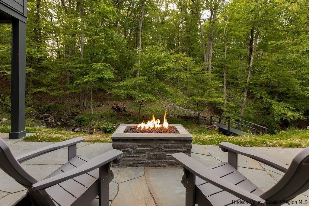 136 Bush Road Stone Ridge, NY 12484 - Photo 30 of 35 a view of a patio with couple of chairs and a fire pit