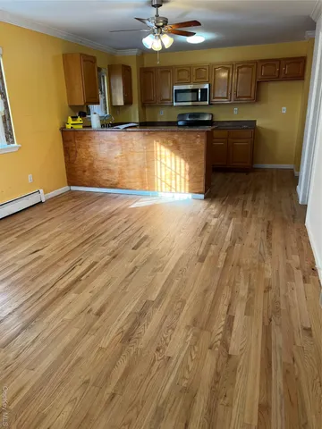 a view of a kitchen with a sink and cabinets