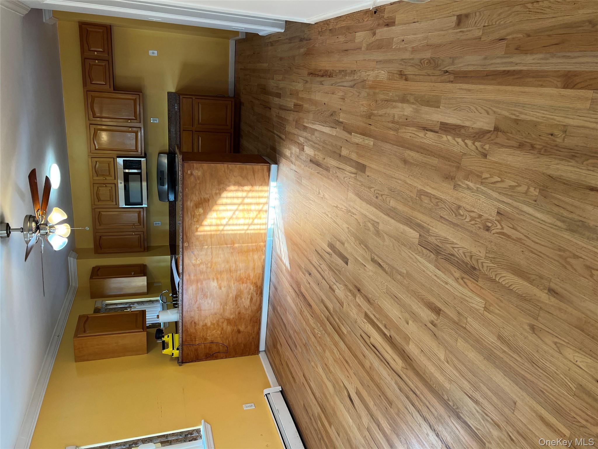 169-11 105th Avenue, Unit 1 Queens, NY 11433 - Photo 3 of 10 a view of a kitchen with a sink and cabinets