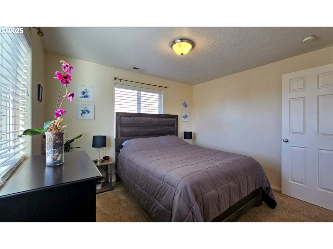 6004 Quartz Avenue Springfield, OR 97478 - Photo 13 of 19 a bedroom with a bed and a dresser