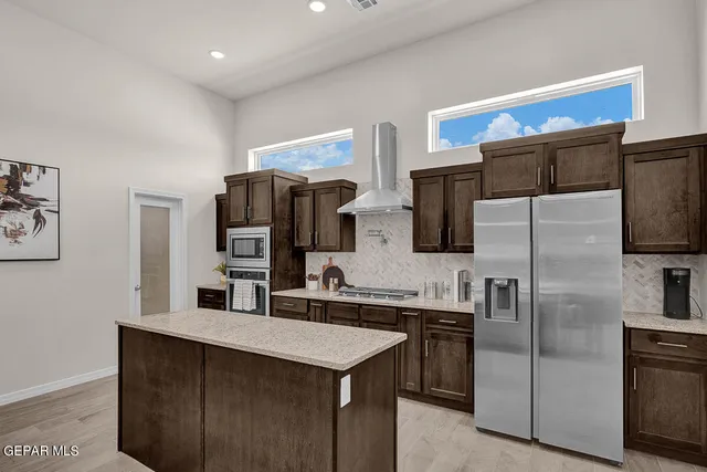 a kitchen with stainless steel appliances a refrigerator and a sink