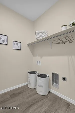 a living room with furniture a flat screen tv and a chandelier