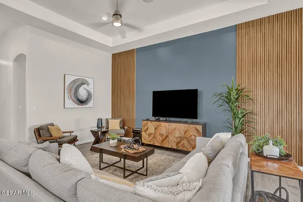 a living room with furniture and a flat screen tv