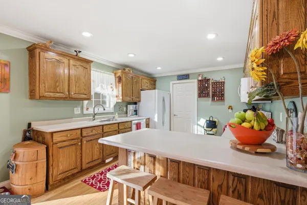a kitchen with stainless steel appliances a dining table chairs and stove