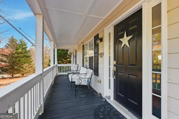a balcony with wooden floor and furniture