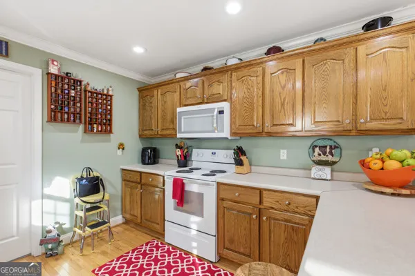 a kitchen with a sink a stove and cabinets