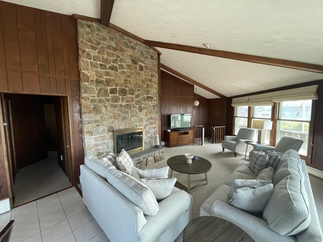 a bedroom with a bed chair and window