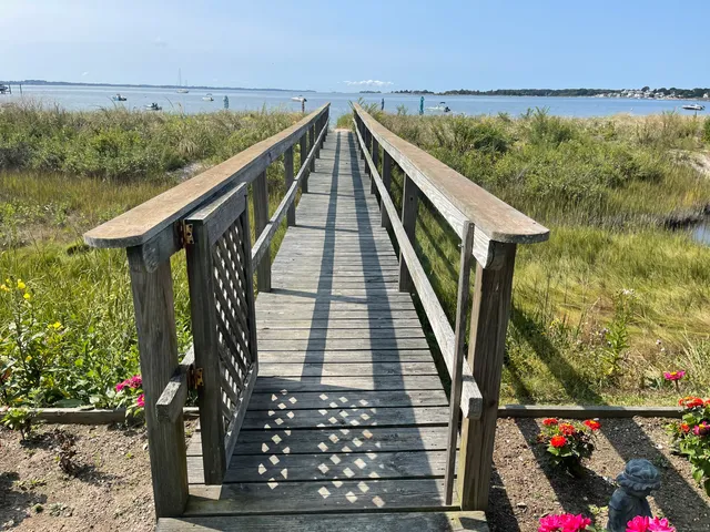 a view of a balcony with wooden floor and outdoor seating