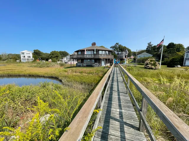 a view of a house with swimming pool and furniture