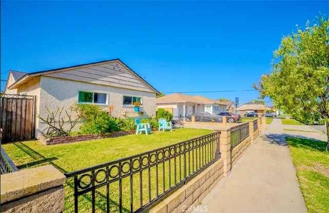 a view of a house with swimming pool and sitting area