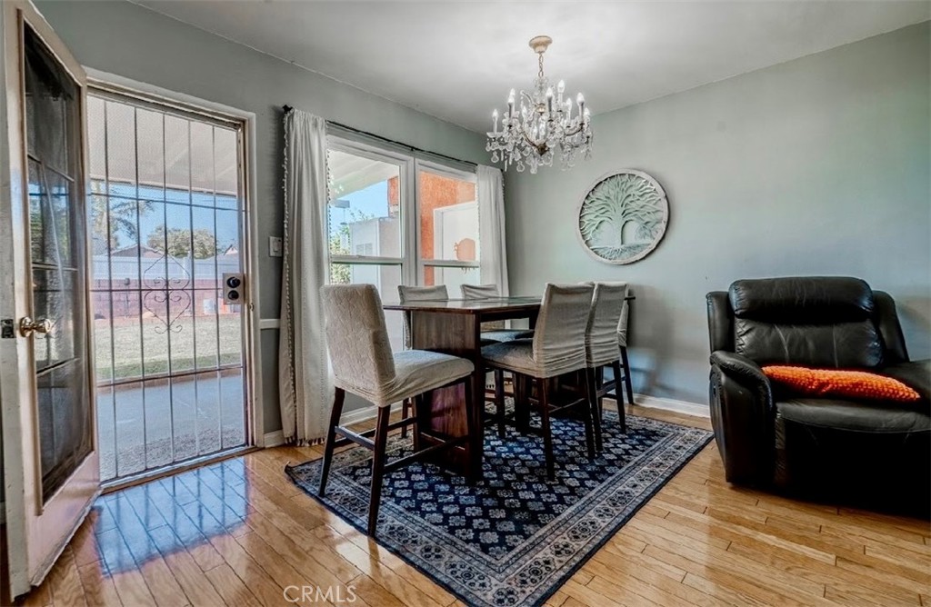 10539 Gridley Road Santa Fe Springs, CA 90670 - Photo 16 of 27 a view of a dining room with furniture and chandelier