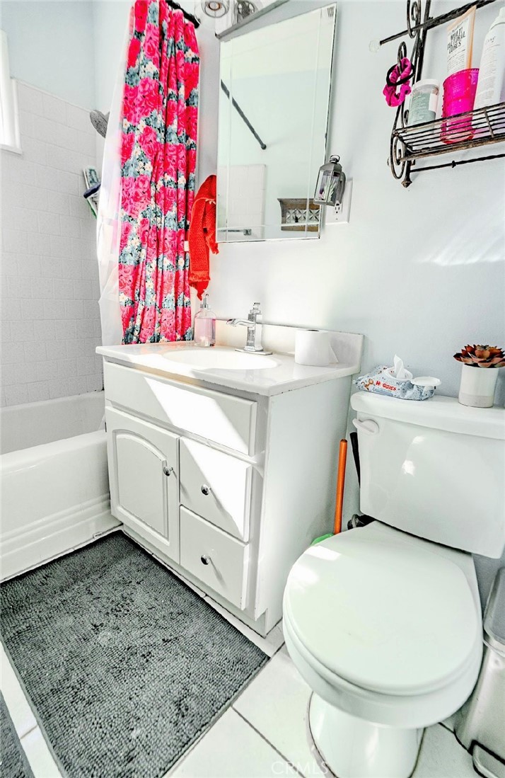 10539 Gridley Road Santa Fe Springs, CA 90670 - Photo 17 of 27 a bathroom with a sink mirror vanity and toilet