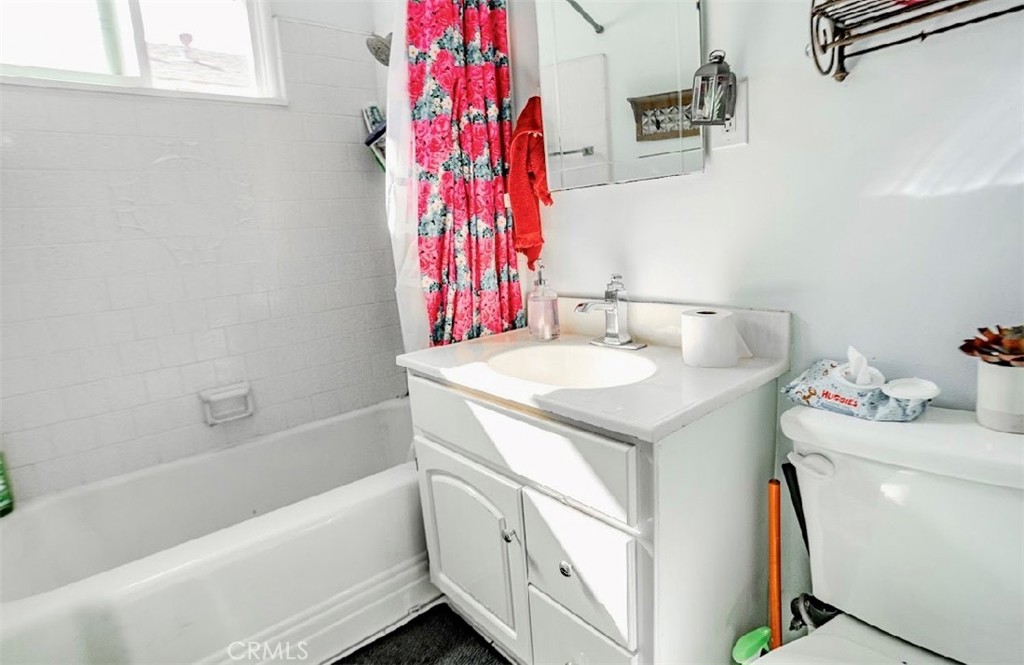 10539 Gridley Road Santa Fe Springs, CA 90670 - Photo 18 of 27 a bathroom with a sink toilet vanity and tub