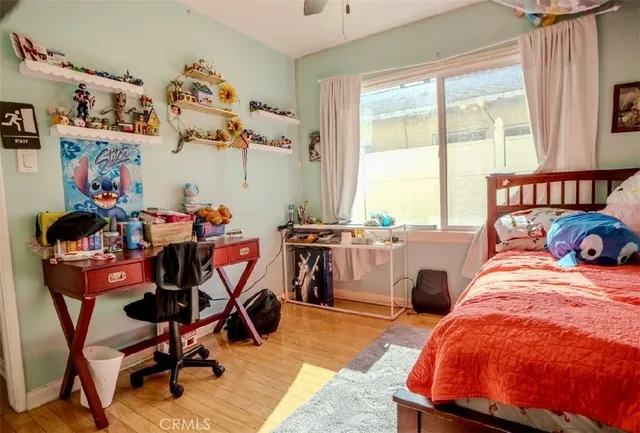 a room with furniture a rug toys and a large window