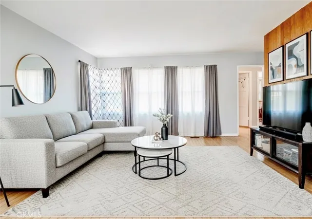 a living room with furniture a window and a flat screen tv