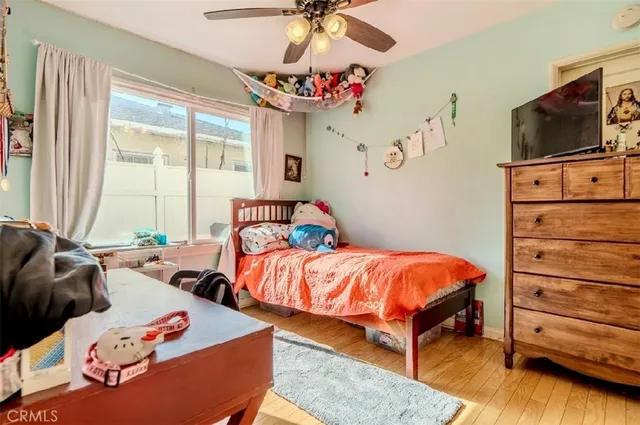 a bedroom with furniture and a flat screen tv