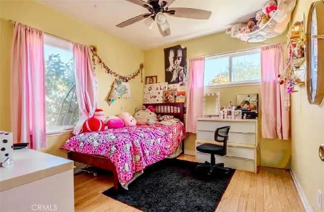 a bedroom with a bed dresser and a window