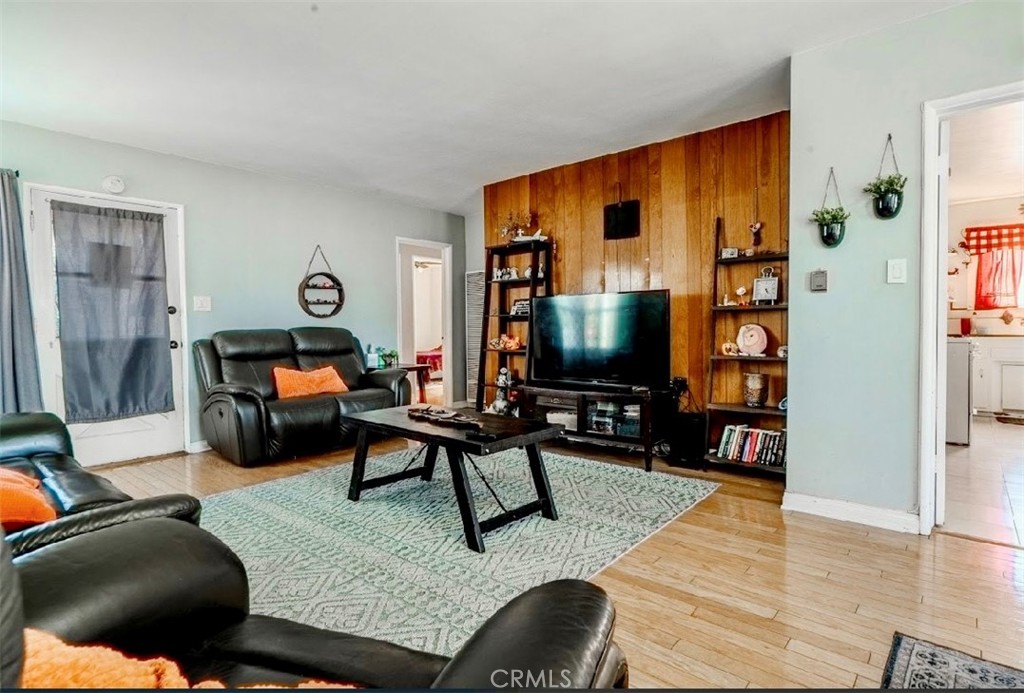 10539 Gridley Road Santa Fe Springs, CA 90670 - Photo 24 of 27 a living room with furniture and a flat screen tv