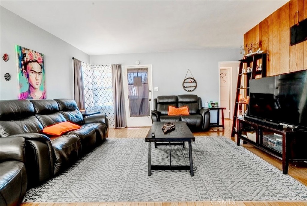 10539 Gridley Road Santa Fe Springs, CA 90670 - Photo 25 of 27 a living room with furniture a flat screen tv and a rug