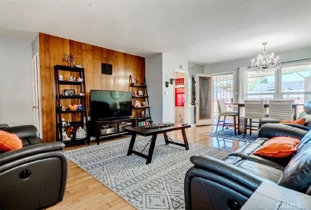 a living room with furniture a flat screen tv and a large window