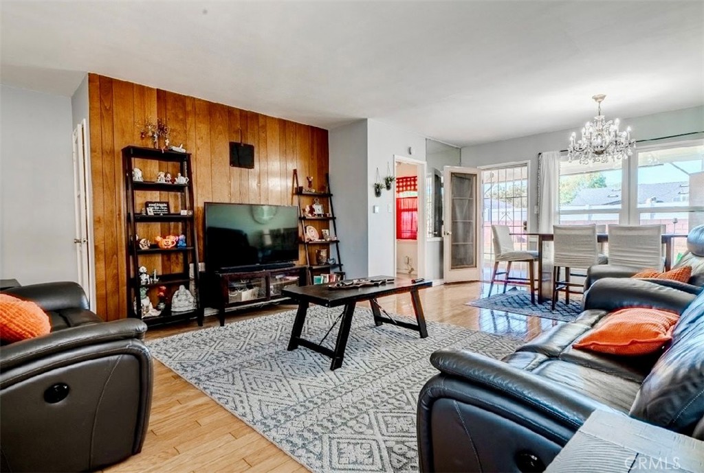 10539 Gridley Road Santa Fe Springs, CA 90670 - Photo 26 of 27 a living room with furniture a flat screen tv and a large window