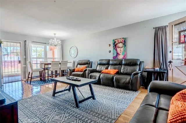 a living room with furniture a rug and a window