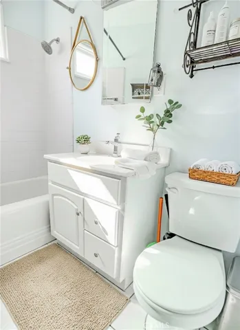 a bathroom with a sink toilet and a mirror