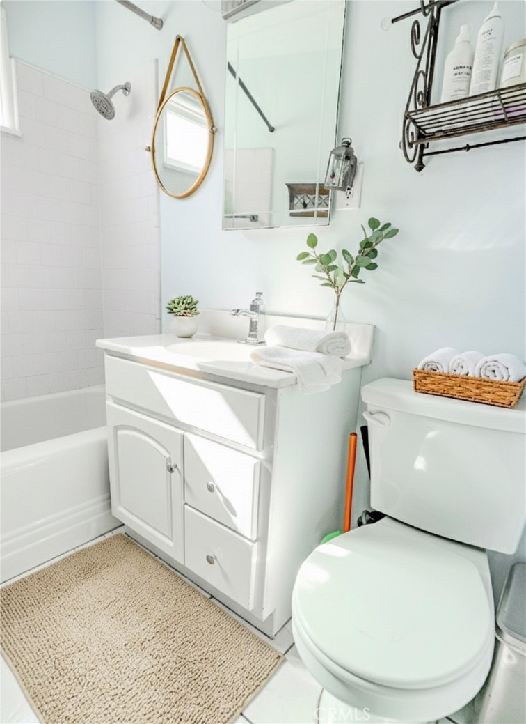 10539 Gridley Road Santa Fe Springs, CA 90670 - Photo 9 of 27 a bathroom with a sink toilet and a mirror