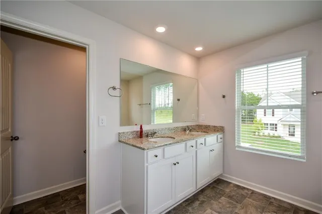 a bathroom with a tub shower and sink