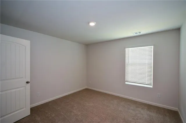 an empty room with closet and window