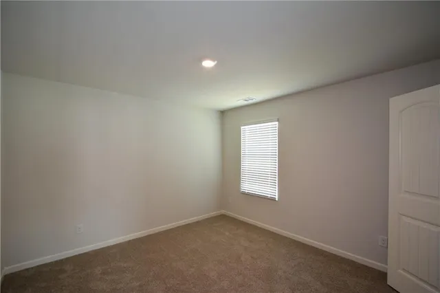 an empty room with closet area