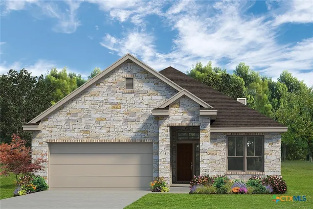 a view of a house with brick walls and a yard