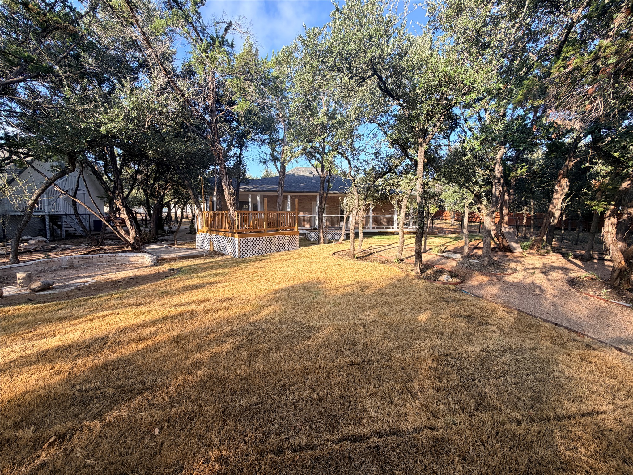 7130 Ranch 2338 Road Georgetown, TX 78633 - Photo 25 of 35 Mature trees shade a spacious backyard complete with a raised wooden deck.