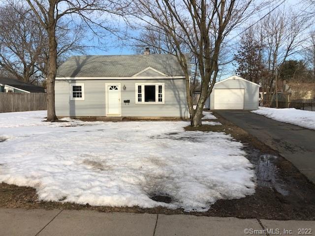 a view of a house with a yard covered in snow