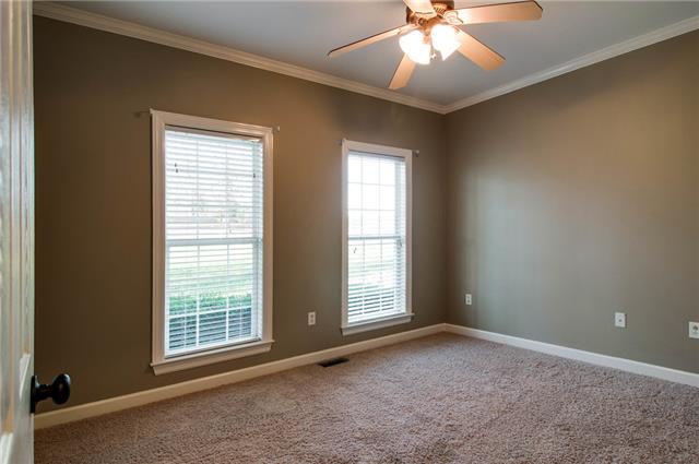 1216 Camp Ravine Road Burns, TN 37029 - Photo 14 of 20 an empty room with chandelier fan and windows