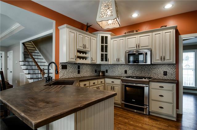 1216 Camp Ravine Road Burns, TN 37029 - Photo 6 of 20 a kitchen with stainless steel appliances granite countertop a sink a stove and cabinets