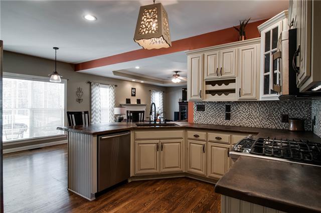 1216 Camp Ravine Road Burns, TN 37029 - Photo 7 of 20 a kitchen with stainless steel appliances a sink a stove and cabinets