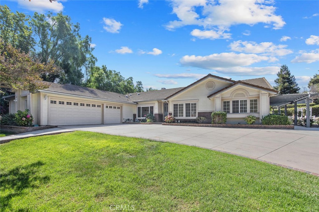 a front view of a house with yard and garage