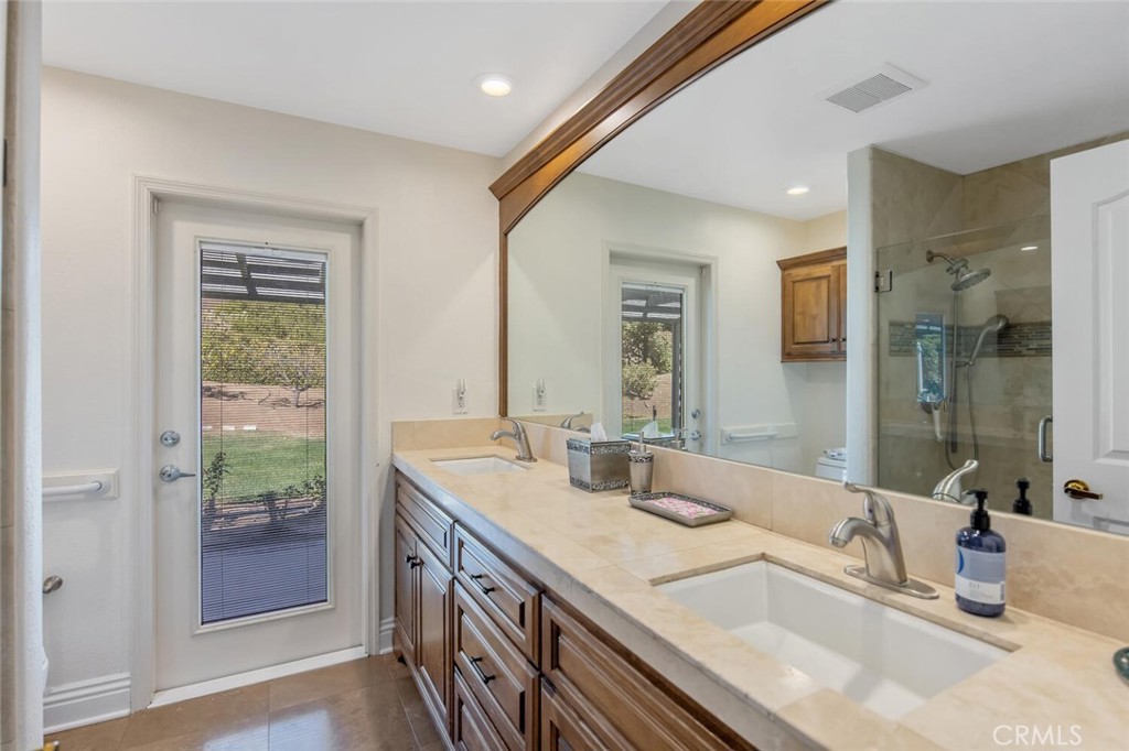 12738 Rosedale Court Camarillo, CA 93012 - Photo 29 of 66 a bathroom with double vanity sinks and a large mirror