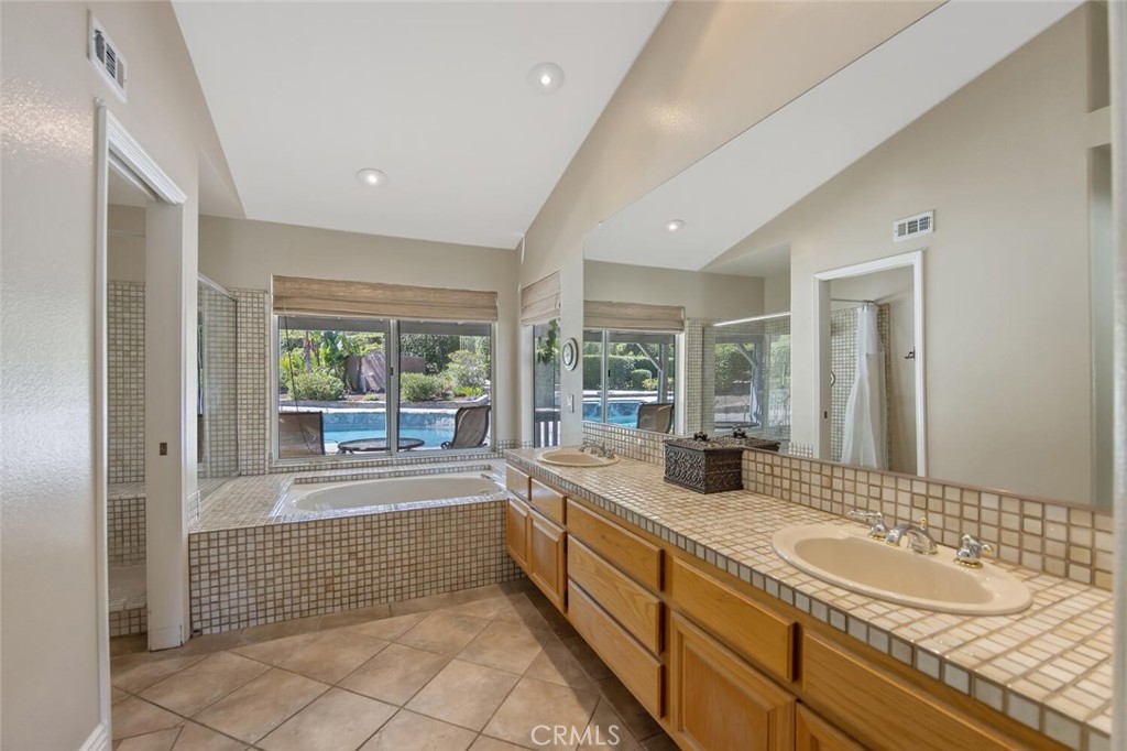 12738 Rosedale Court Camarillo, CA 93012 - Photo 35 of 66 a bathroom with a tub sink and mirror