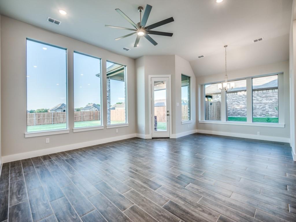 139 Lakeview Circle Pilot Point, TX 76258 - Photo 5 of 19 Unfurnished living room with plenty of natural light, ceiling fan with notable chandelier, and visible vents