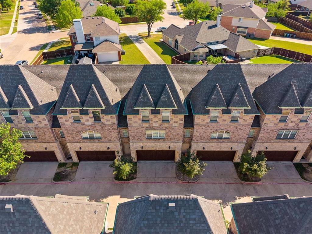 an aerial view of a house with a garden and parking space