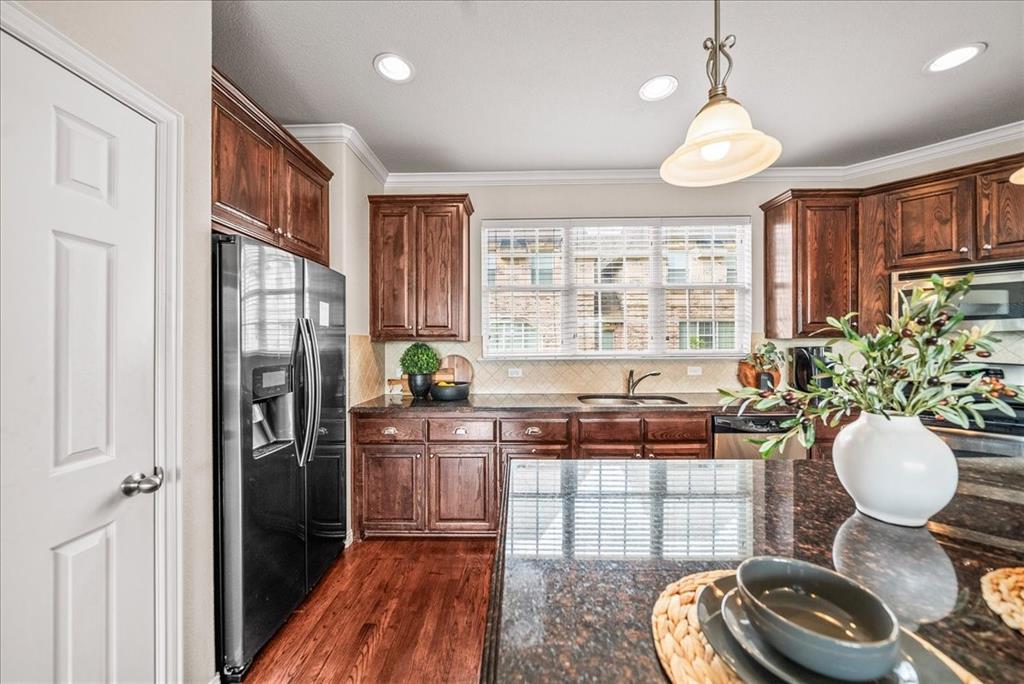 2700 Club Ridge Drive, Unit 34 Lewisville, TX 75067 - Photo 11 of 27 a kitchen with stainless steel appliances granite countertop a stove a refrigerator and a wooden cabinets
