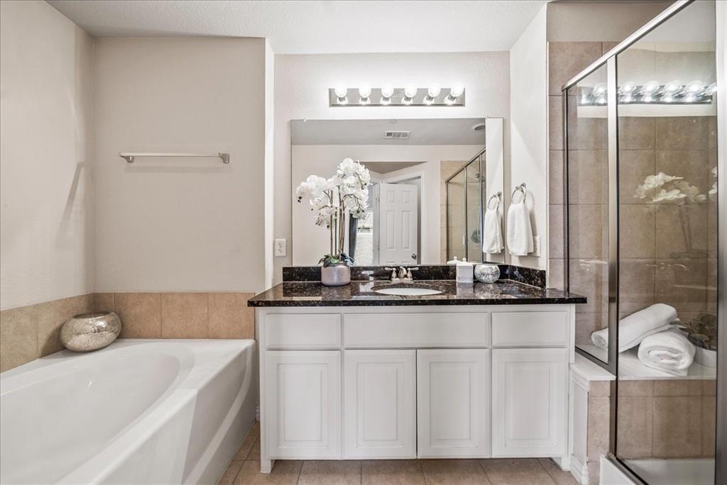 2700 Club Ridge Drive, Unit 34 Lewisville, TX 75067 - Photo 18 of 27 a bathroom with a granite countertop sink a mirror and shower