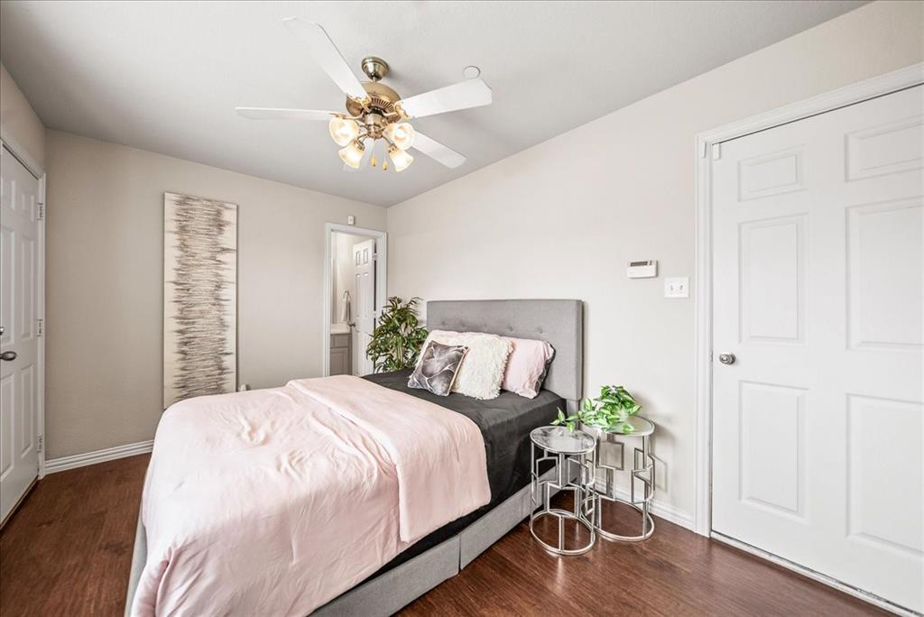 2700 Club Ridge Drive, Unit 34 Lewisville, TX 75067 - Photo 20 of 27 a bedroom with a bed and a chandelier