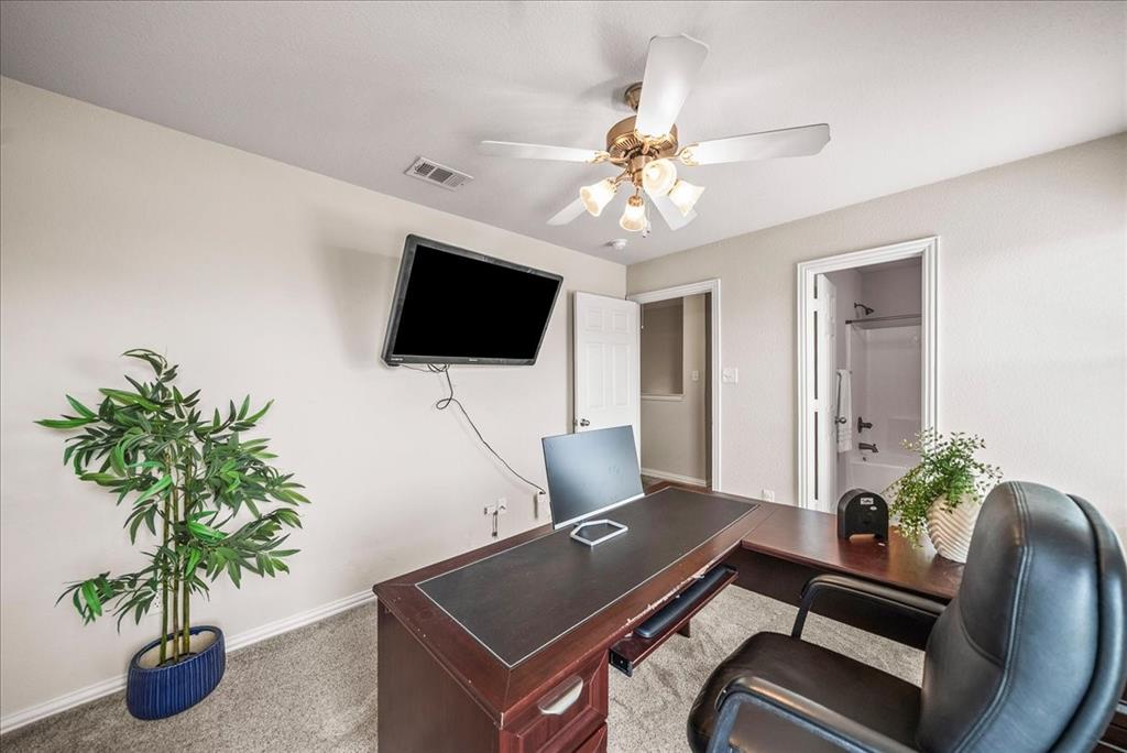 2700 Club Ridge Drive, Unit 34 Lewisville, TX 75067 - Photo 22 of 27 a living room with furniture and a flat screen tv