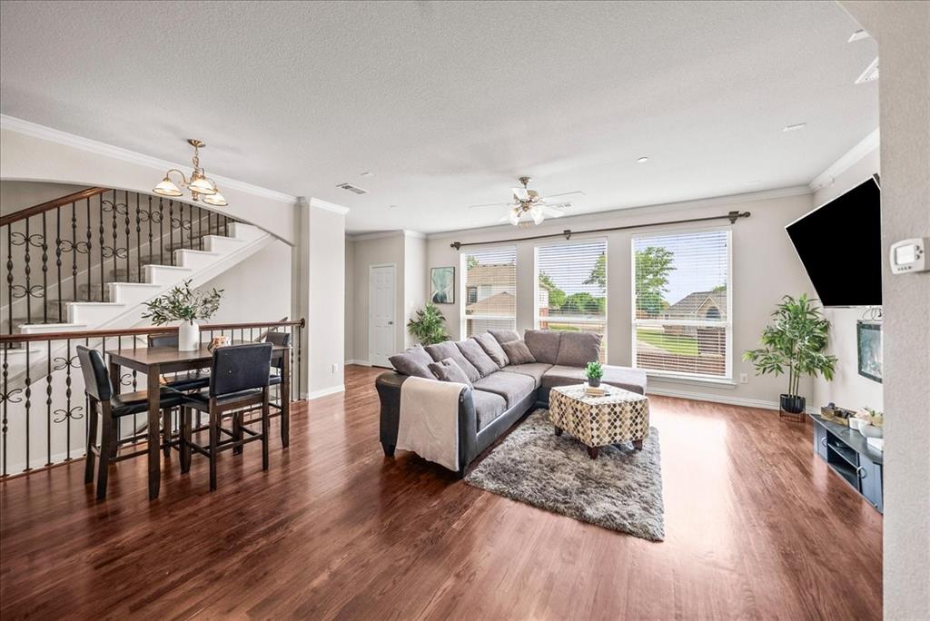 2700 Club Ridge Drive, Unit 34 Lewisville, TX 75067 - Photo 4 of 27 a living room with furniture wooden floor and a flat screen tv