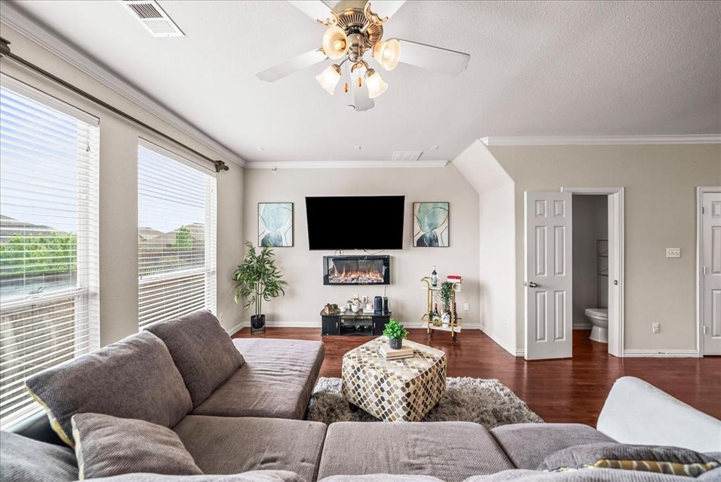 2700 Club Ridge Drive, Unit 34 Lewisville, TX 75067 - Photo 7 of 27 a living room with furniture a flat screen tv and a large window