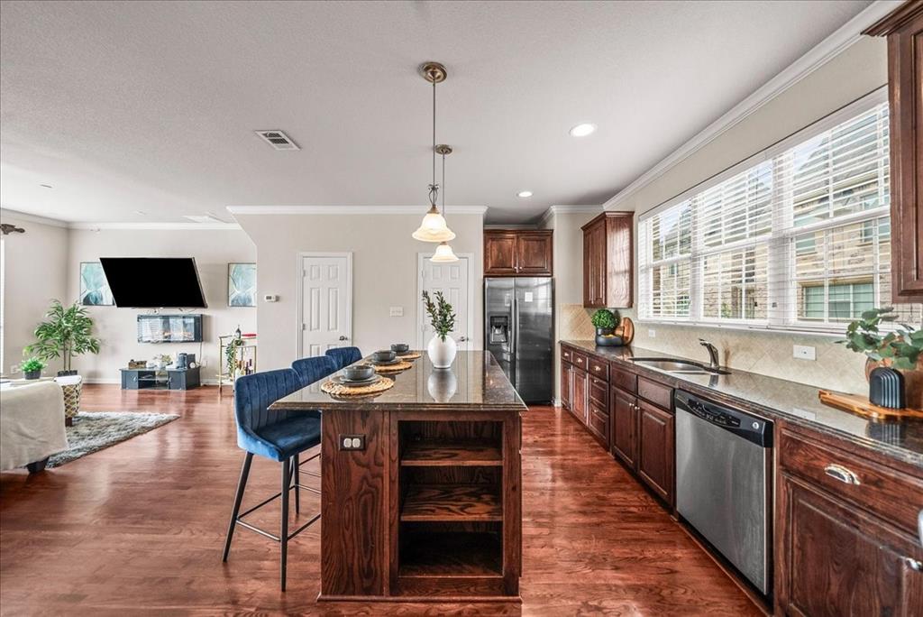 2700 Club Ridge Drive, Unit 34 Lewisville, TX 75067 - Photo 8 of 27 a kitchen with stainless steel appliances kitchen island granite countertop a sink and cabinets